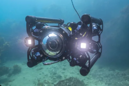 Dive professional preparing underwater filming gear