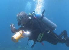 Diver using underwater filming equipment during a marine shoot